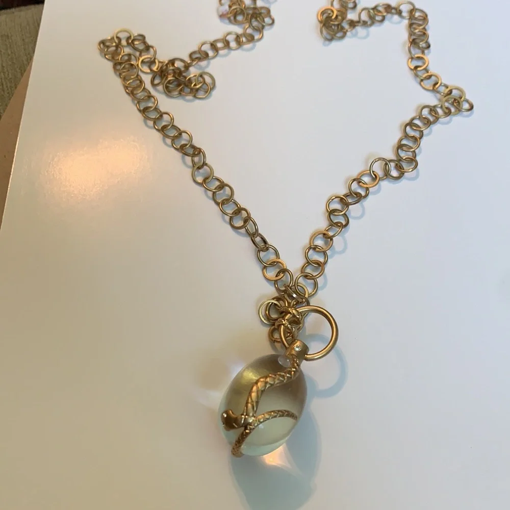 Vintage golden Snake wrapped around an elongated oval crystal